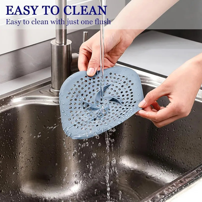 Rinsing the hair catcher clean under a running tap