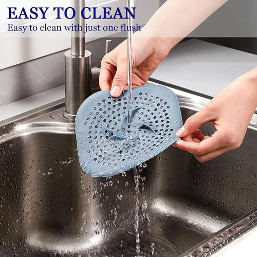 Rinsing the hair catcher clean under a running tap